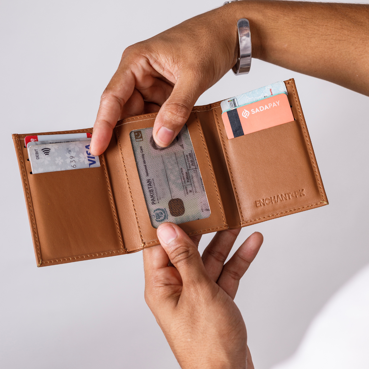 Discover the Enchant.pk Signature Trifold Leather Wallet, a perfect blend of sophistication and practicality. Crafted from premium leather, it features 8 card slots, a deep cash compartment, and an ID slot. Enjoy timeless design and superior craftsmanship at the best price in Pakistan.